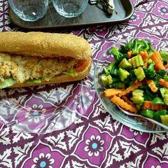 A picture of Egg burger with veg salad.