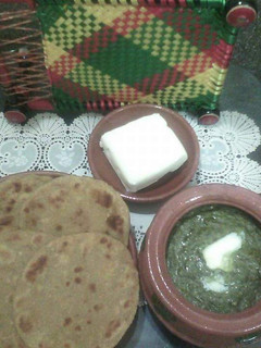 A picture of Sarson ka saag with butter & makai ki roti.