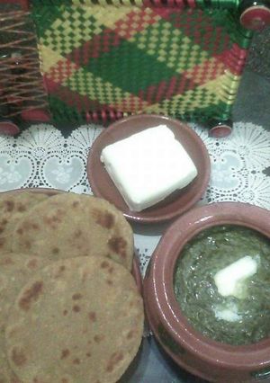 A picture of Sarson ka saag with butter & makai ki roti.