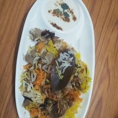 A picture of Veg biryani with burani raita.