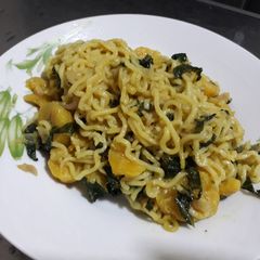 A picture of Indomine with plantain and vegetable(ugu).