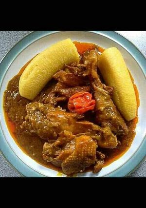 A picture of Chicken stew with ripe bananas.