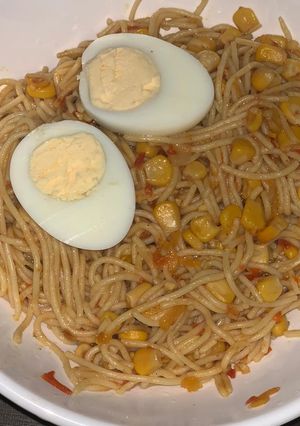 A picture of Corn spaghetti with hard boiled egg.