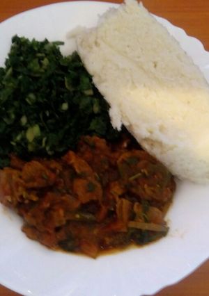 A picture of Ugali, steamed spinach and wet fried beef.