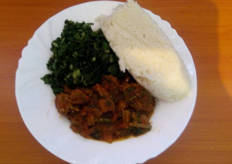 Ugali, steamed spinach and wet fried beef