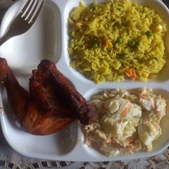 A picture of Fried Rice/chicken peri peri/egg salad.