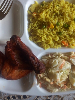 A picture of Fried Rice/chicken peri peri/egg salad.