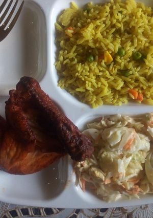 A picture of Fried Rice/chicken peri peri/egg salad.