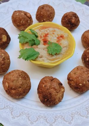 A picture of Falafel balls with hummus.