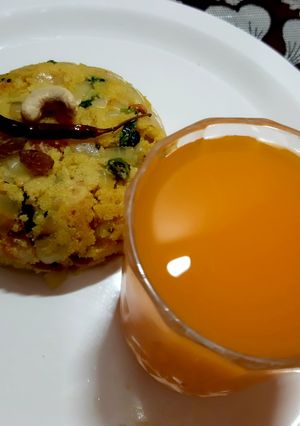 A picture of Rawa upma and orange juice.