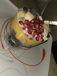 A picture of Custard smoothy garnished with Apple&grapes.