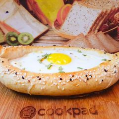 A picture of Khachapuri with four cheese.