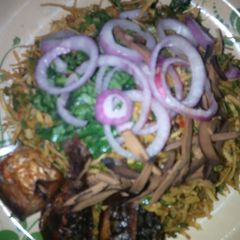 A picture of Warm Abacha with fried fish.