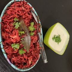 A picture of Beetroot Biryani with raita.
