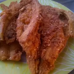 A picture of Fried fish with masala seeds.