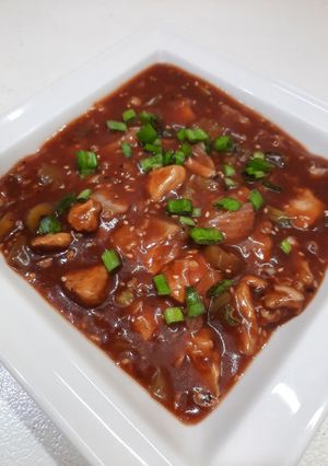 A picture of Chicken manchurian with fried rice.
