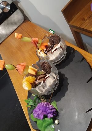 A picture of Banana icecream with fusion fruits.