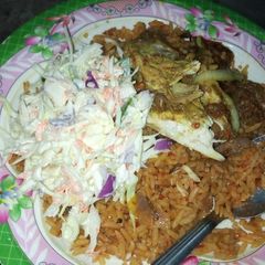 A picture of Jollof rice coslow, pepper chicken.
