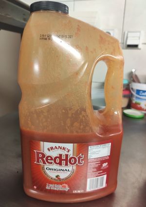 A picture of Buffalo sauce (large, for catering).