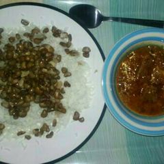 A picture of Rice and beans with stew.