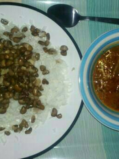 A picture of Rice and beans with stew.