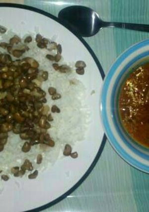 A picture of Rice and beans with stew.