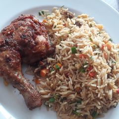 A picture of Jollof rice with grilled chicken.