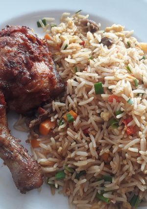 A picture of Jollof rice with grilled chicken.