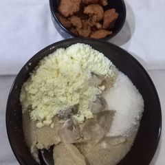 A picture of Ijebu garri with milk and groundnut cake.