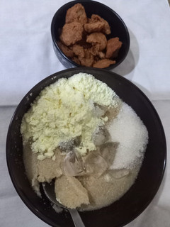 A picture of Ijebu garri with milk and groundnut cake.