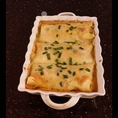 A picture of Crab and Shrimp Enchiladas with Hatch Chili Sauce.