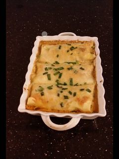 A picture of Crab and Shrimp Enchiladas with Hatch Chili Sauce.