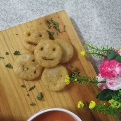 A picture of Potatoes smiley with tomato soup.