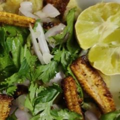 A picture of Spiced fried aloo with sizziled baby corn.