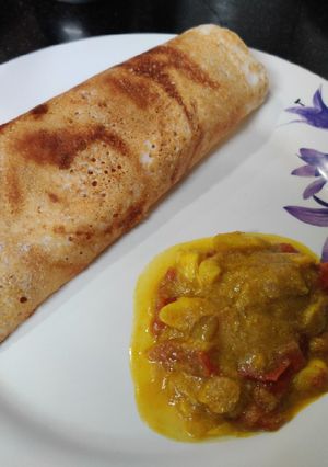 A picture of Dosa and Garlic Kurma.