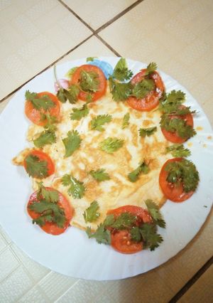 A picture of Fried eggs with fresh vegetables.