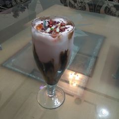 A picture of Stawberry Milk shake wth dry fruits nd fruit Jelly.