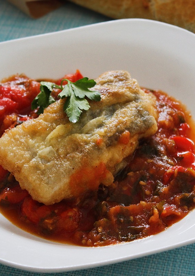 Una foto de Bacalao rebozado con pimientos y tomate