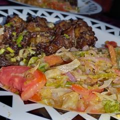 A picture of Pan fried pork with sauted lettuce.