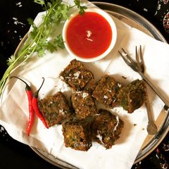 A picture of Kothimbir Vadi (Coriander & Gram Flour Pakoras / Fritters).