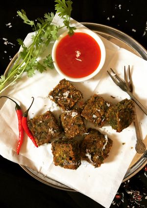 A picture of Kothimbir Vadi (Coriander & Gram Flour Pakoras / Fritters).