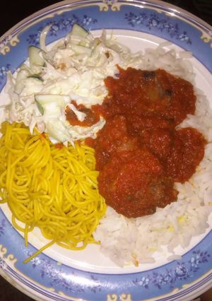 A picture of Rice and stew with coslow.