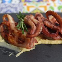 A picture of Roasted octopus on fragrant chickpea puree.