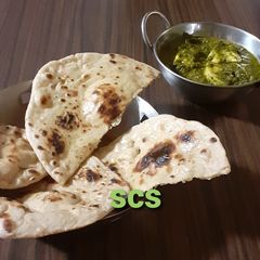 A picture of Whole wheat naan on tawa (with yeast).