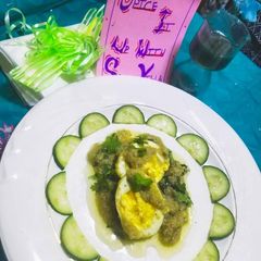 A picture of Green Egg Malai Curry.