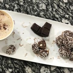A picture of Chocolate coconut balls with cappuccino.