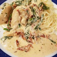 A picture of Creamy garlic chicken w/ sundried tomatoes & spinach.
