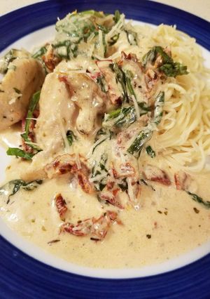 A picture of Creamy garlic chicken w/ sundried tomatoes & spinach.