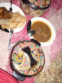 A picture of Fried yam and egg, plantain and meat pepper soup.