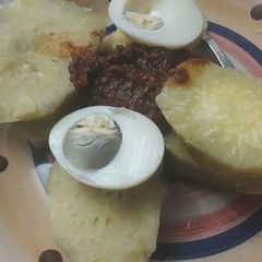 A picture of Sweet potatoes with boiled egg and sauce.